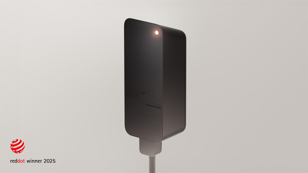 amina C EV charger in grey finish with integrated status light, Red Dot Award winner 2025 for product design, highlighting Scandinavian design and engineering quality.