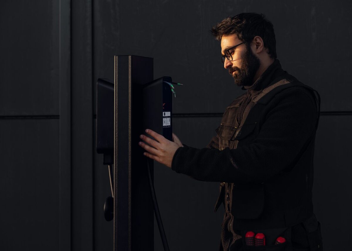 Technician installing wall-mounted EV charger