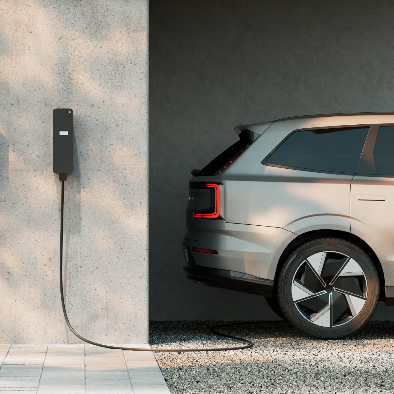 amina wall-mounted EV charger installed on a concrete wall in a residential parking space, charging an electric car in a modern multi-dwelling setting.