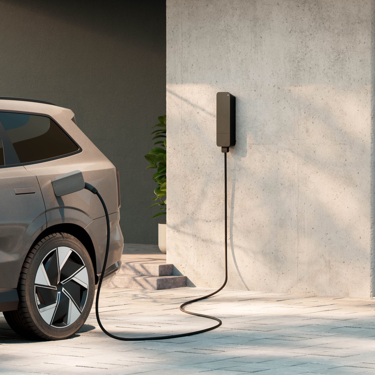 amina M wall-mounted EV charger installed on a concrete wall in a residential parking space, charging an electric car in a modern multi-dwelling setting.